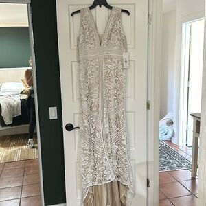 Lace wedding dress with mesh chest area. Never worn size 16 that was altered.